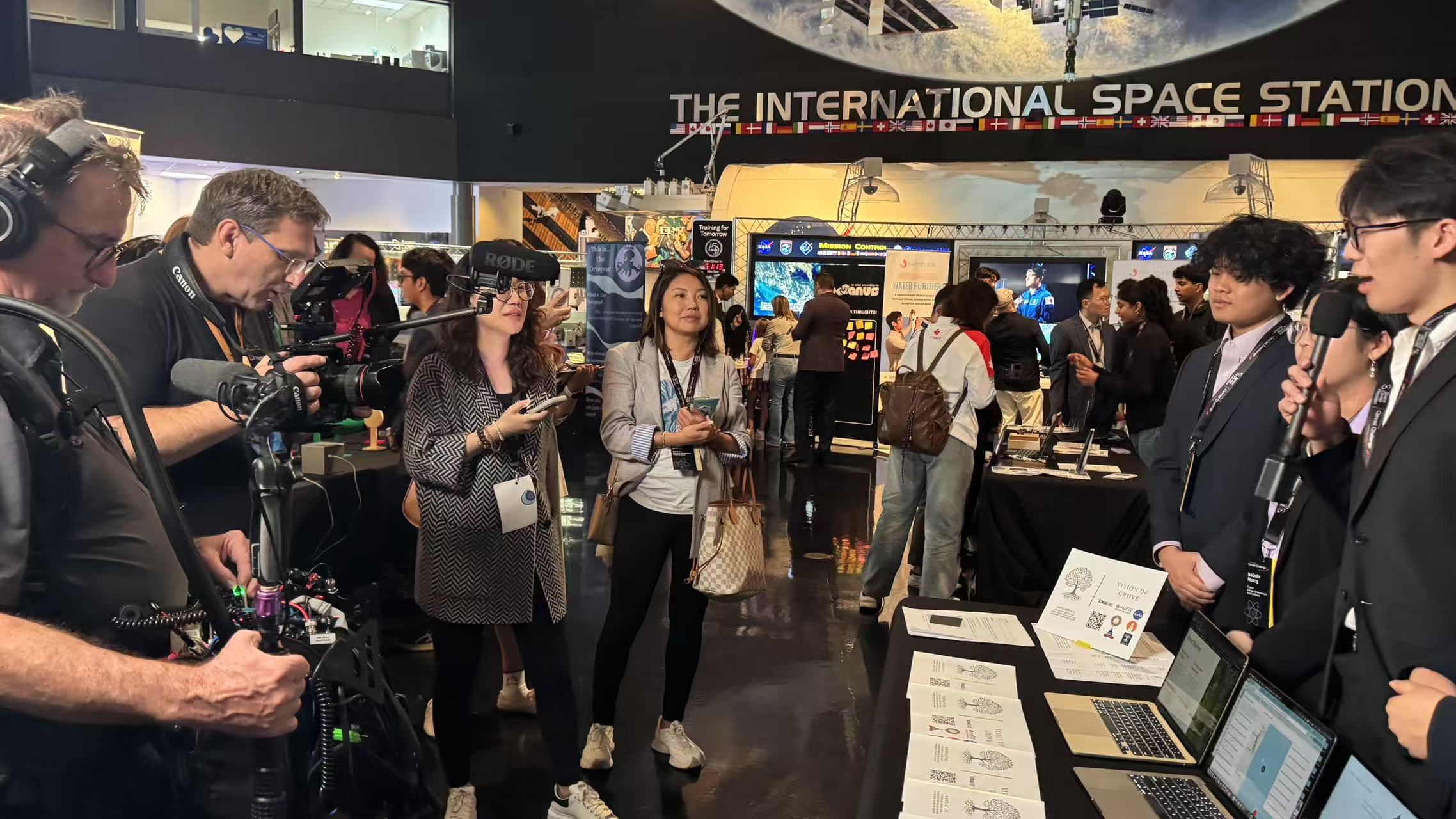 Team being filmed at International Space Station exhibit